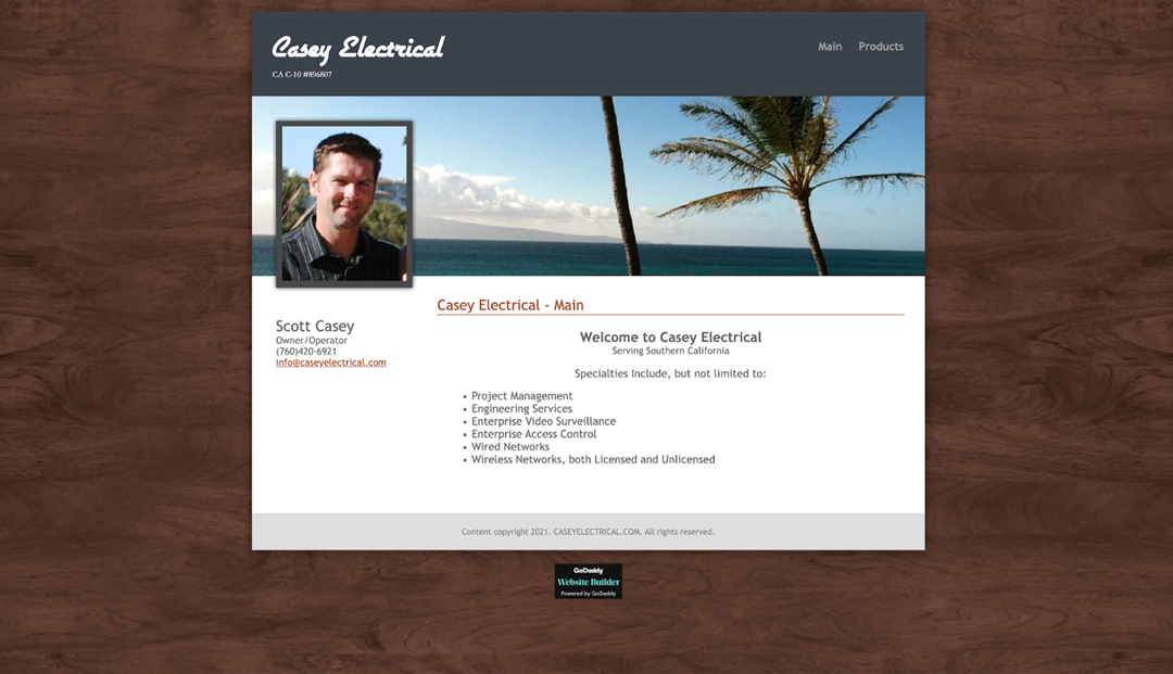 A website page for Casey Electrical featuring a photo of Scott Casey and a list of electrical services offered. The header displays a beach scene with a palm tree. Links for "Main" and "Products" are present.